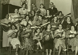 Group of union members playing guitars and mandolins on stage