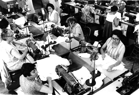 Rows of women sewing in a garment shop