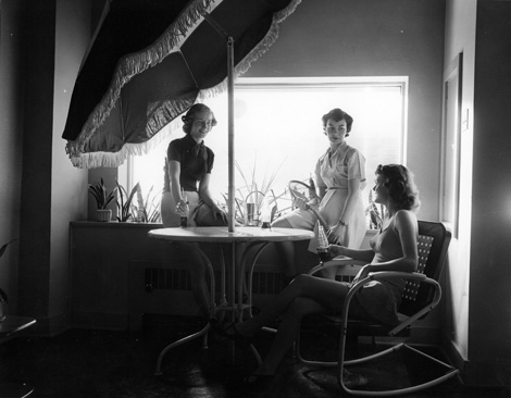Women conversing and drinking soda at Unity House, circa 1955